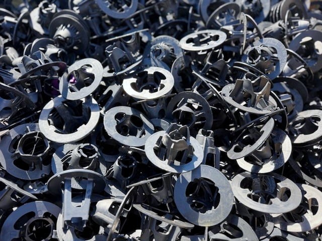A pile of plastic reinforcing bar chairs