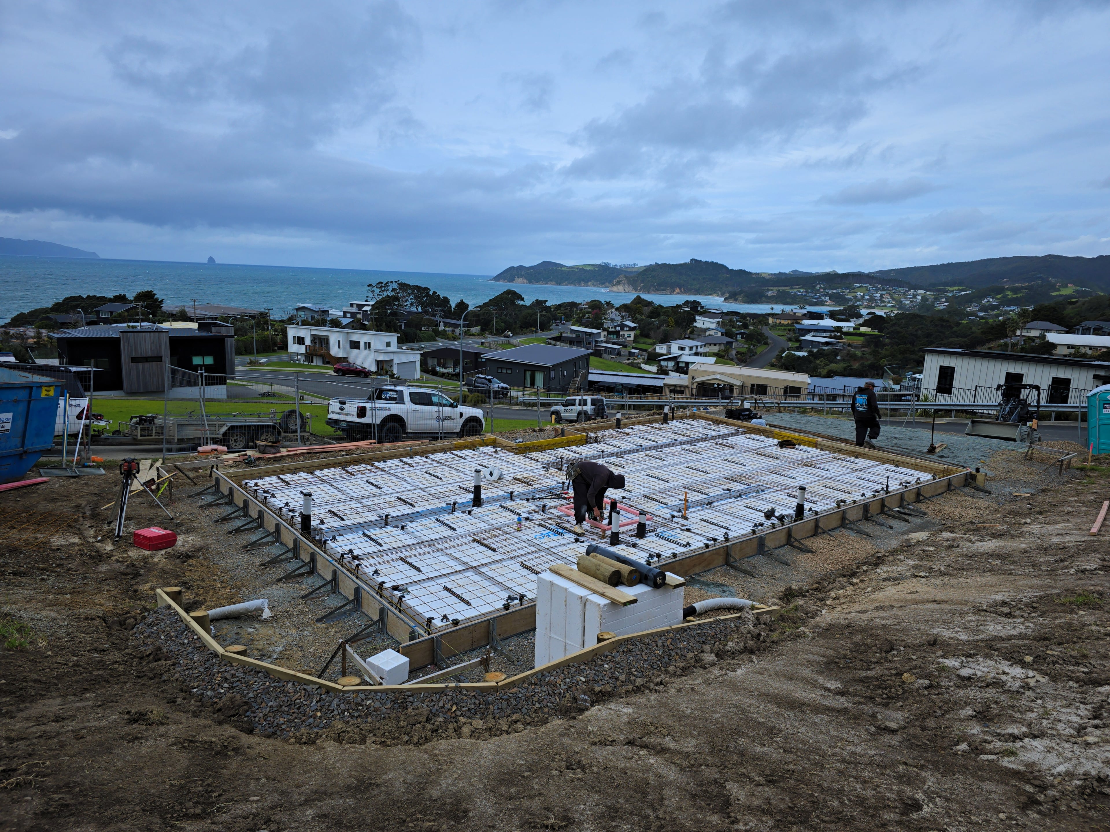 A pod floor being prepared on a hillside site looking out to the sea
