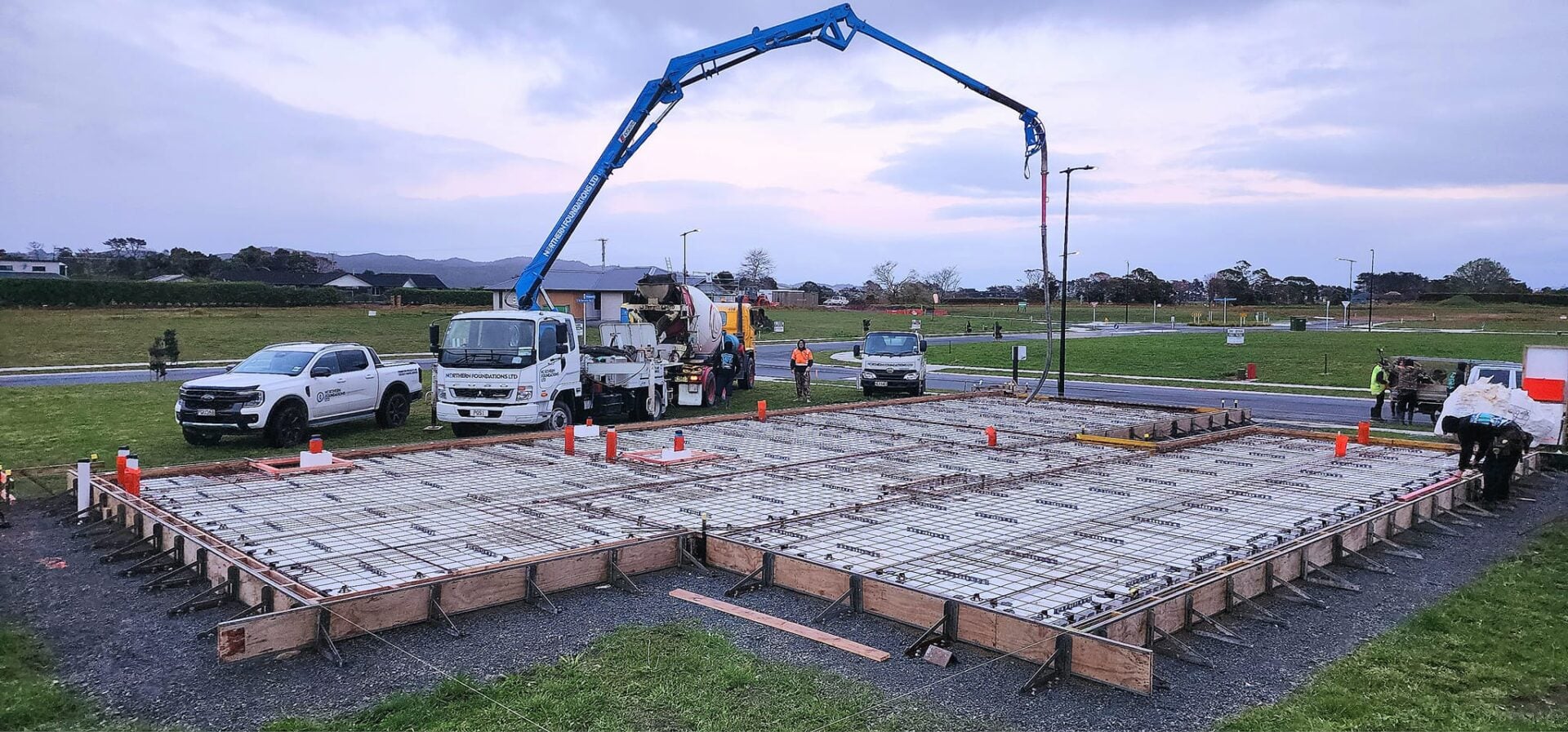 The Northern Foundations boom pump reaching over a boxed foundation, ready to pour