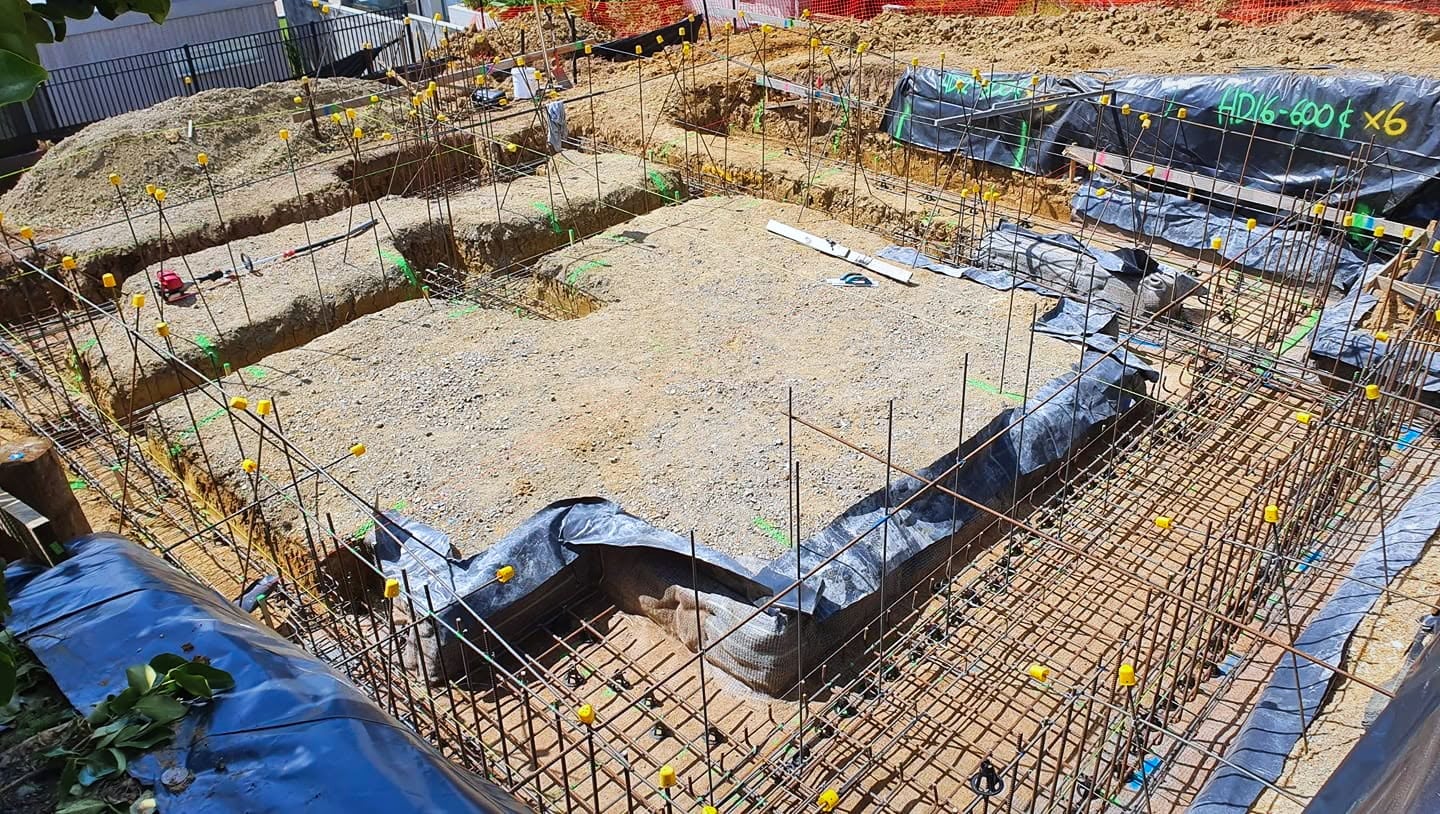 Residential foundation trenches with reinforcing steel set out