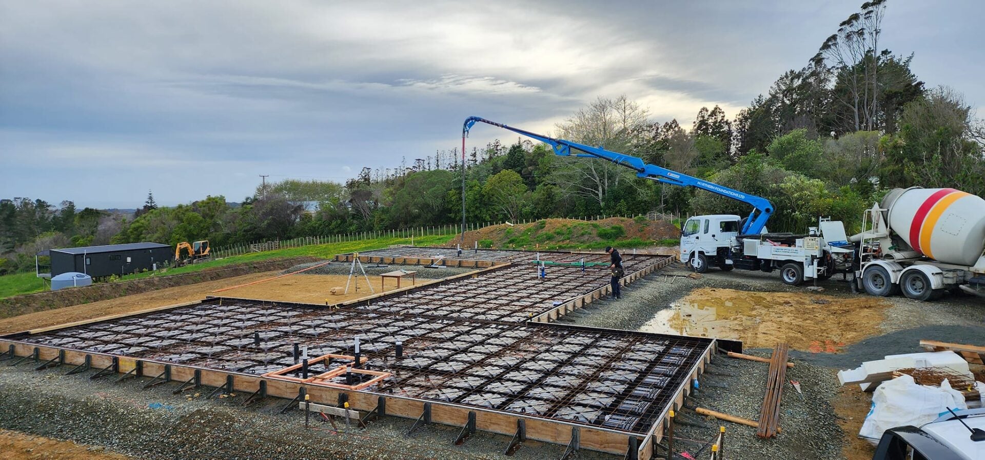 The boom pump and a concrete truck at a rib raft foundation